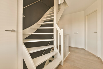 a white staircase with black and white wallpapers on the walls in a modern home office space is visible