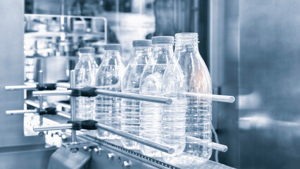 Bottle. Industrial production of plastic pet bottles. Factory line for manufacturing polyethylene bottles. Transparent food packaging.