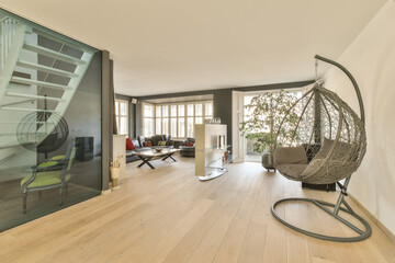 a living room with wood flooring and glass door leading to an open balcony area that looks out onto the street