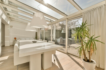 a bathroom with a large plant in the center of the room and an open skylight over the bathtub