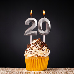 Birthday candle number 20 - Anniversary cupcake on black background