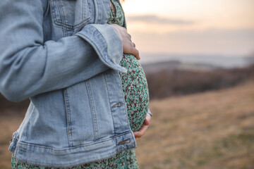 Pregnant woman at sunset