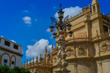 Fototapeta na wymiar 'Cathedral de Sevilla' picture from the street. The cathedral, is open to public, you can see beautiful gothic style architecture unusually bright of the sunny weather