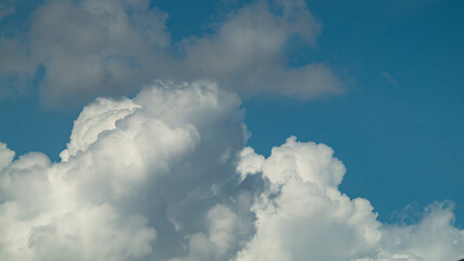 White fluffy cloud. Fluffy clouds at the blue sky. White cloud closeup