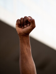 Close-up of a raised fist of an African person at a demonstration against racism.Black Lives...