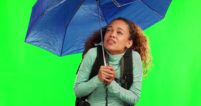 Woman, umbrella and rain weather by green screen for travel, adventure and thinking in cold with cover in mockup. Young student girl, parasol and regret in winter wind for walking, journey and hiking