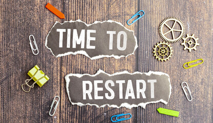 TIME TO RESTART text on paper sheet with chart, dice, spectacles, pen,