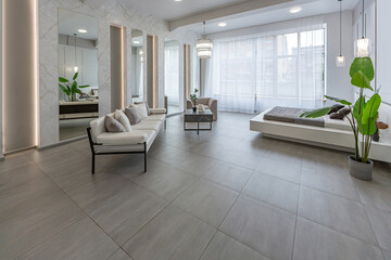 stylish bright modern bedroom interior with decorative niches with LED lighting and a huge panoramic window in gray and white colors and geometric shapes