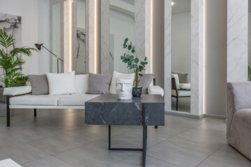 stylish bright modern bedroom interior with decorative niches with LED lighting and a huge panoramic window in gray and white colors and geometric shapes