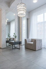 stylish bright modern bedroom interior with decorative niches with LED lighting and a huge panoramic window in gray and white colors and geometric shapes