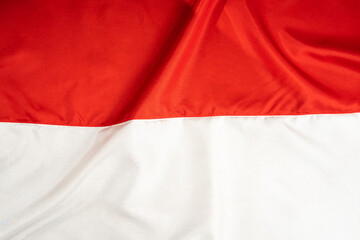 Indonesian national flag. Wavy red and white fabric texture