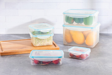 A kitchen countertop featuring six efficient plastic food storages system with variety of fruits