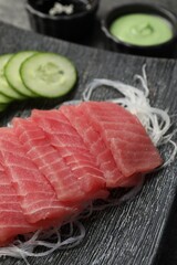 Tasty sashimi (pieces of fresh raw tuna) and glass noodles on plate, closeup