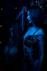 Portrait of a beautiful go-go dancer. Atmospheric blue club light. Party concept, night club....