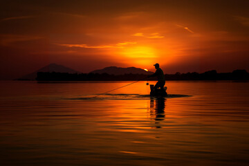 Naklejka na ściany i meble sunset silhouette fishing