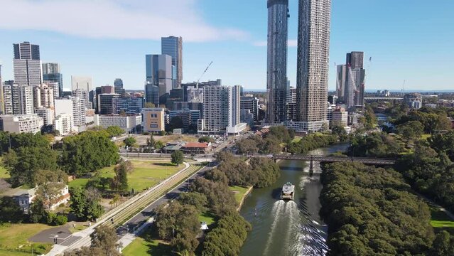 Aerial drone view above Parramatta River in Greater Western Sydney, NSW, Australia with Parramatta CBD in the background as a ferry travels to Parramatta Wharf  