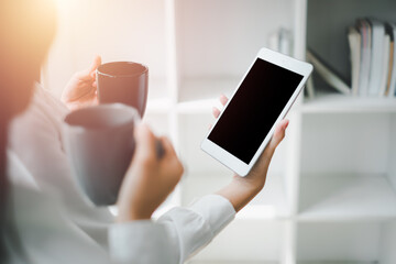Woman using and looking blank screen digital tablet with friends in office, Blank screen laptop...