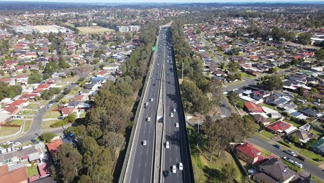 Aerial drone view above the South Western M5 Motorway at Casula in Sydney, NSW Australia looking in the south direction 