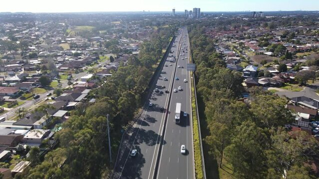 Aerial drone view above the South Western M5 Motorway at Casula in Sydney, NSW Australia with Liverpool CBD in the background 