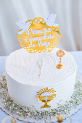 a cake with white frosting and gold accents