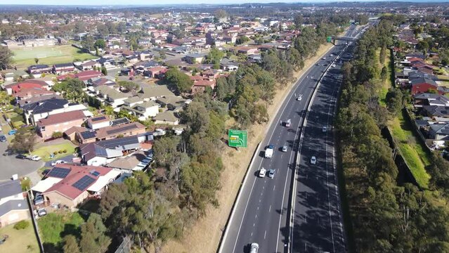 Aerial drone view above the South Western M5 Motorway at Casula in Sydney, NSW Australia looking in the south direction 