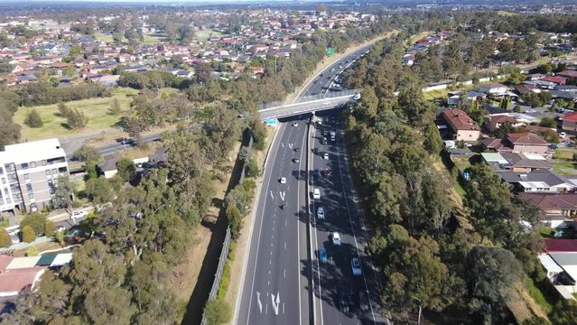 Aerial drone view above the South Western M5 Motorway at Casula in Sydney, NSW Australia looking in the south direction 