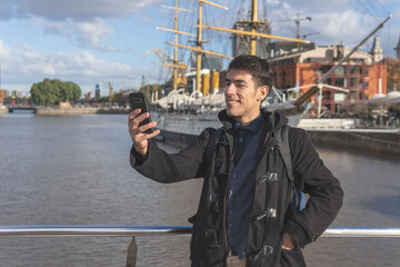 Happy tourist taking a selgie in Puerto Madero, Buenos Aires, Argentina