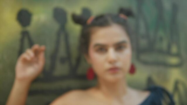 feminist frida kahlo inspired look, red earrings, serious pose, eye contact, looking into camera, young gen z female, emancipation, politics, culture, paradigm shift, emancipate women, feminism. 