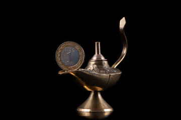 Aladdin's magic lamp and 1 riyal coin of the Kingdom of Saudi Arabia