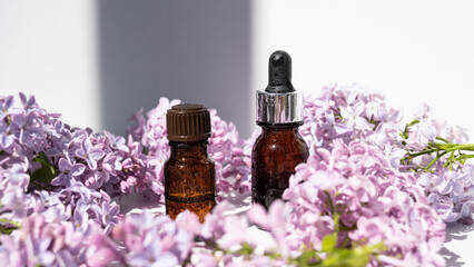 Lilac flowers aroma oil, flowers essential oil, pure essence.    Essential Oils lilac. Spa oil with lilac flowers. Pipette with aroma oil and lilac flowers. Selective focus.