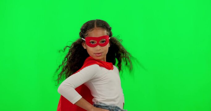 Girl kid, superhero and green screen with mask, strong and justice with hands on hips for mockup. Young female child, power and portrait with confidence, red cape and stop crime by studio background