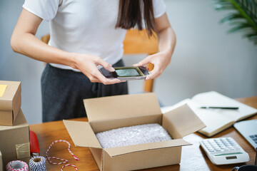 Asian woman preparing package delivery box Shipping for shopping online delivery mail service people and shipment concept