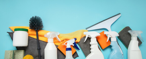 Cleaning products. Bottles, rubber gloves and sponge. Housework concept, top view.