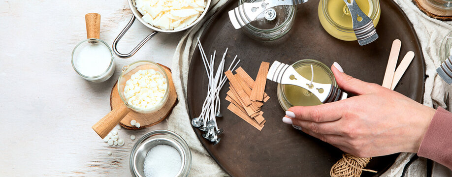 Set for homemade natural eco soy wax candles, Woman making decorative aroma candle at table.