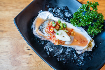 delicious fresh raw oyster wirh spicy sauce