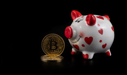 Coin with bitcoin cryptocurrency symbol and blue piggy bank on black background