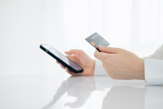 Cropped image of business lady using credit card to pay for online purchase