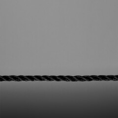 Black rope close-up on black background. Selective focus.