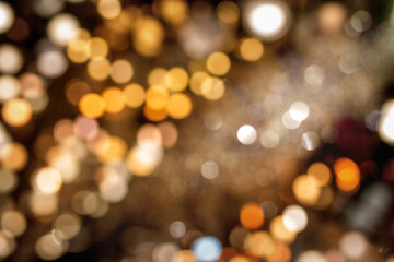 Glittering golden bokeh, abstract background. Falling gold particles, perfectly usable for Christmas, luxury, success, celebration.