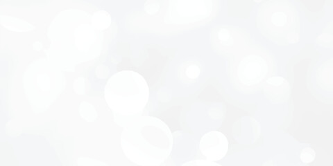 Abstract silver bokeh background with white light at center. The bokeh on the white background blurred the natural gray and white. Bokeh colorful glows sparkle.