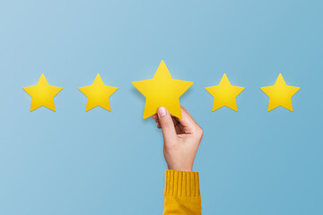 Hand putting star icon for giving five star rating. Improve rating, service rating, feedback,...