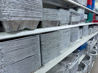 A view of several shelves dedicated to disposable aluminum foil baking trays, on display at a local...