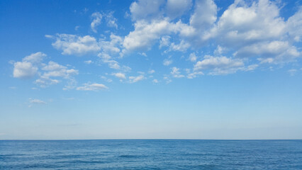 Naklejka na ściany i meble beautiful landscape on the coast of the beach and sea waves against the background of the blue sky