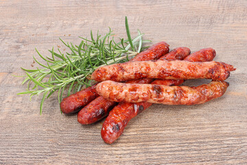 sausages and merguez grilled on wooden background 