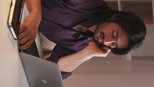 Vertical video. Study fatigue. Home e-learning. Distance education. Exhausted tired bored sleepy guy falling asleep watching virtual lesson on laptop.