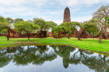 Fototapeta na wymiar Tower (prang) of Wat Phra Ram is reflected in pond