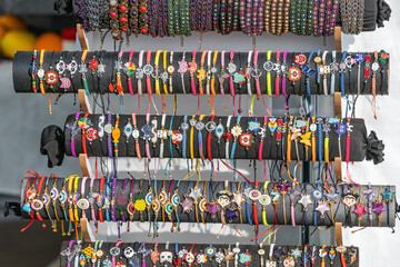 Trendy handmade leather bracelets and wristbands for sale at artisans market. Handcraft souvenir at flea market. Purchase of elegant souvenirs