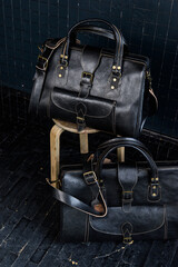 black leather travel bags indoors photo on black background