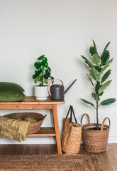 Bedroom interior with oak bench, pillow, blankets, homemade flowers and watering can. Cozy house concept © okkijan2010
