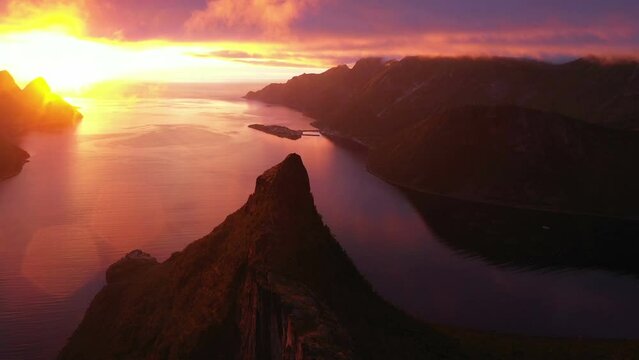 Sunset over Fjord and Mountain on Senja Island in Norway, aerial view from drone